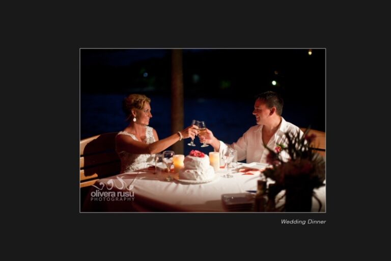 A candlelit wedding dinner for two set along the pier at night, Chabil Mar Resort