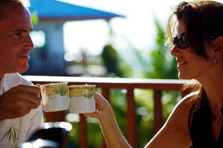 A couple toasting on the veranda of a sea-facing villa, Chabil Mar Resort