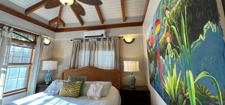 A villa bedroom with a hardwood ceiling and a painted mural, Chabil Mar Resort