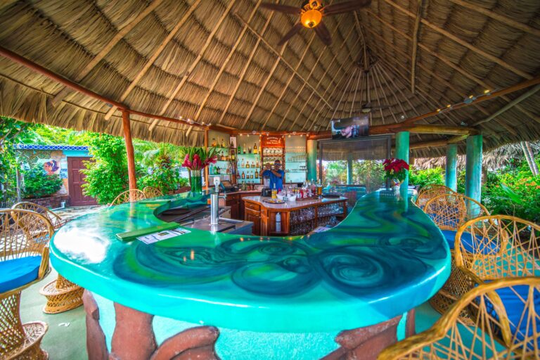 The Kaleidoscope beach bar, its turquoise resin bar top gleaming, Chabil Mar Resort