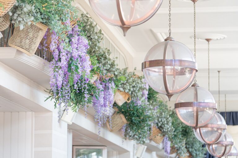 Wisteria and greenery dressing a terrace, beneath copper lanterns, Chantal Flores Design