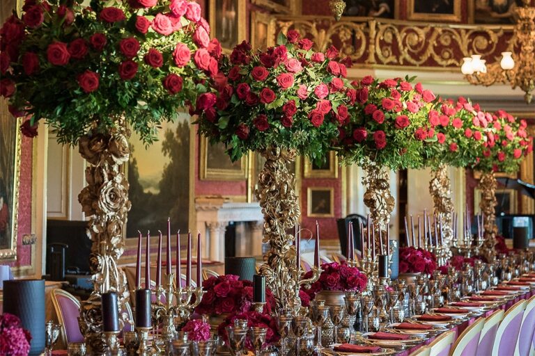 Tall arrangements of red roses in a grand dining room, Chantal Flores Design