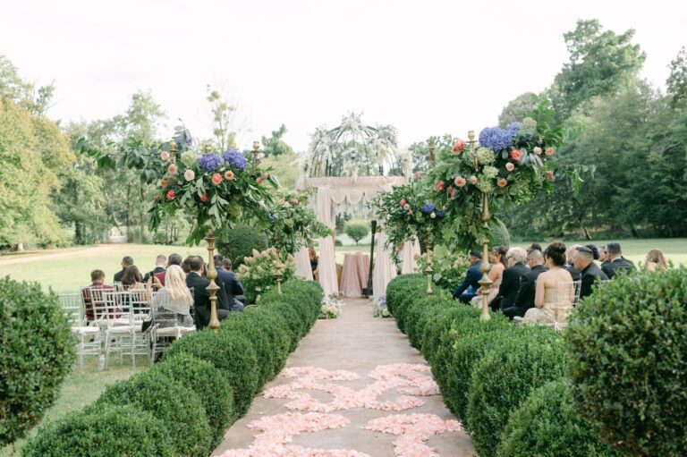 Garden ceremony along a hedge-lined aisle, Chateau Challain