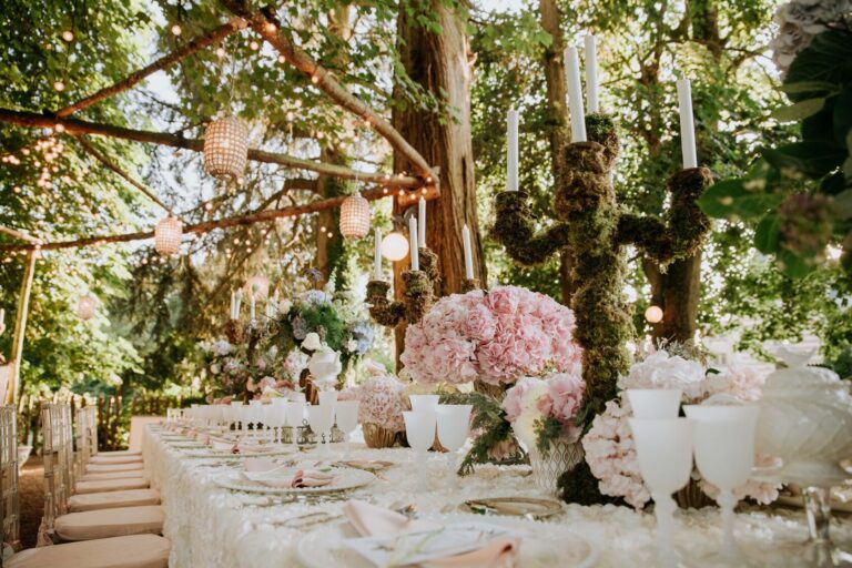 Reception table dressed with flowers and candles among the trees, Chateau Challain