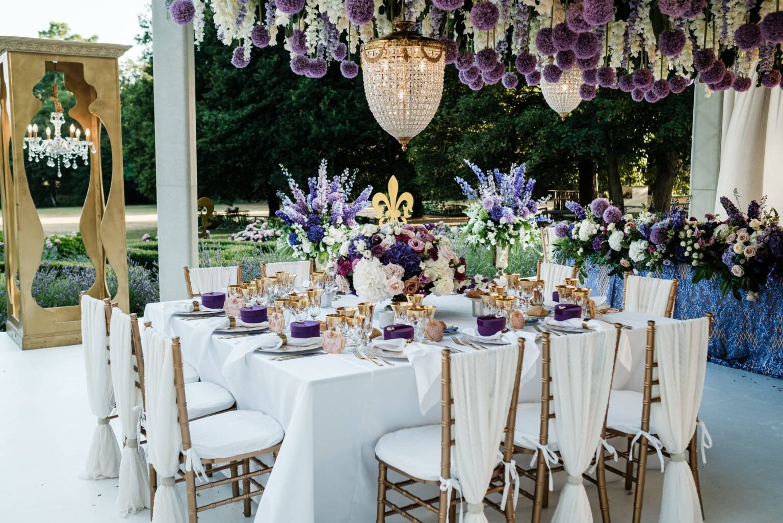 Reception tables beneath a hanging floral ceiling