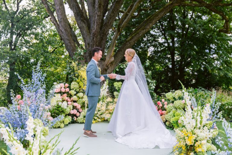 Vows beneath a floral arrangement in the park, Chateau Mcely