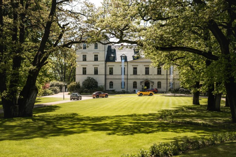 The chateau seen across the lawn of the English park, Chateau Mcely