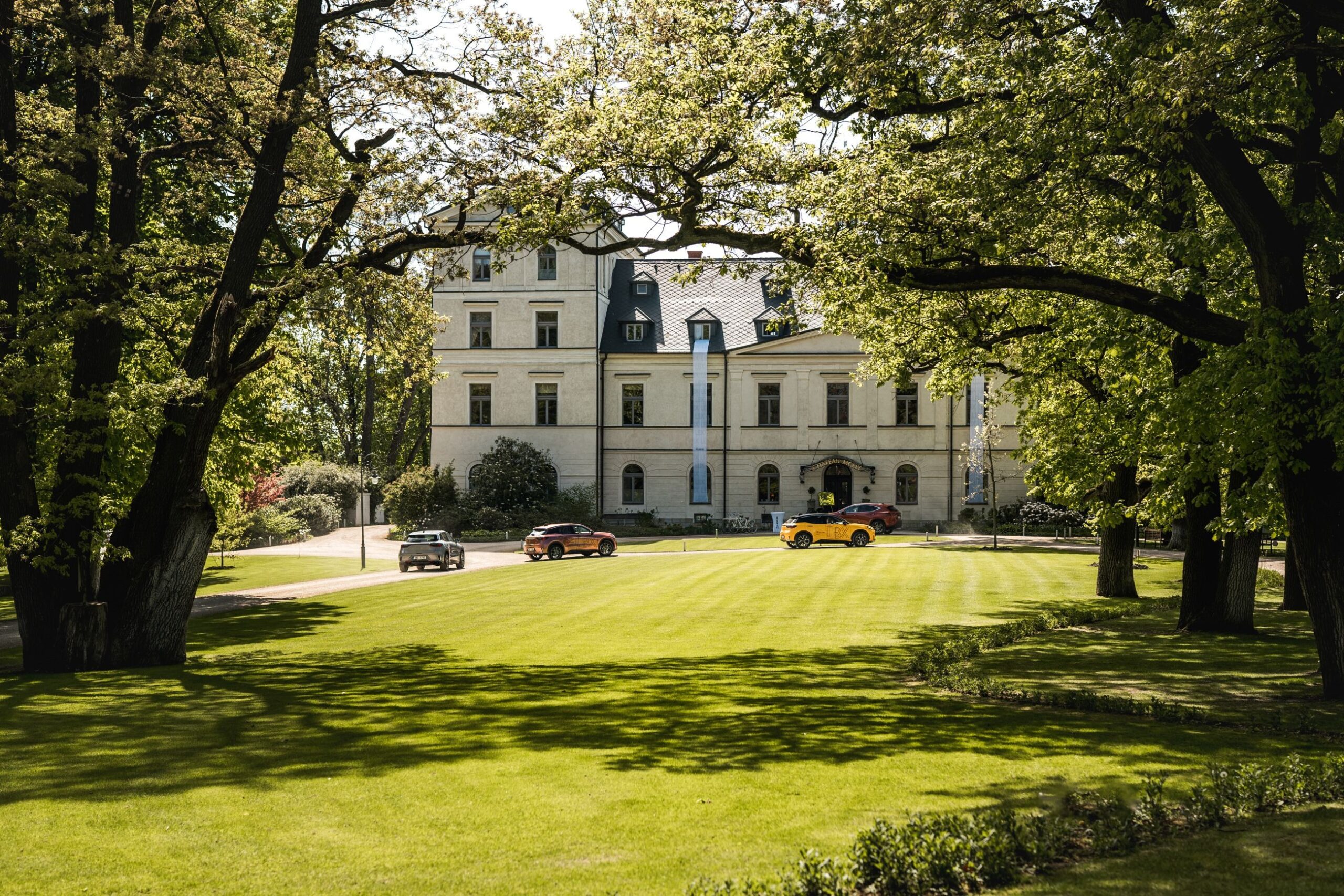 The chateau seen across the lawn of the English park, Chateau Mcely