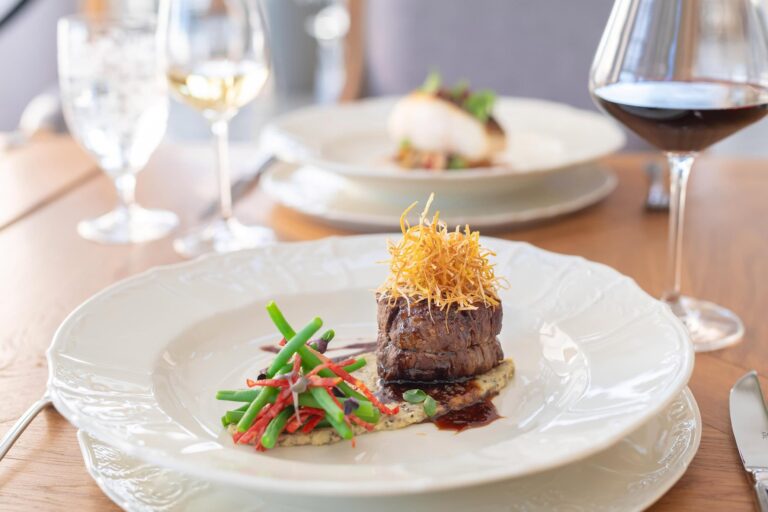Beef fillet and wine at the restaurant, Chateau Mcely