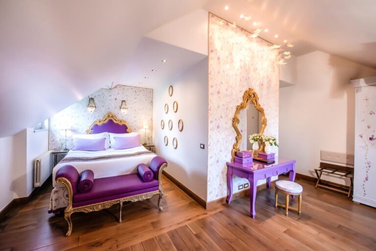 A room with a purple upholstered bench, Chateau Mcely