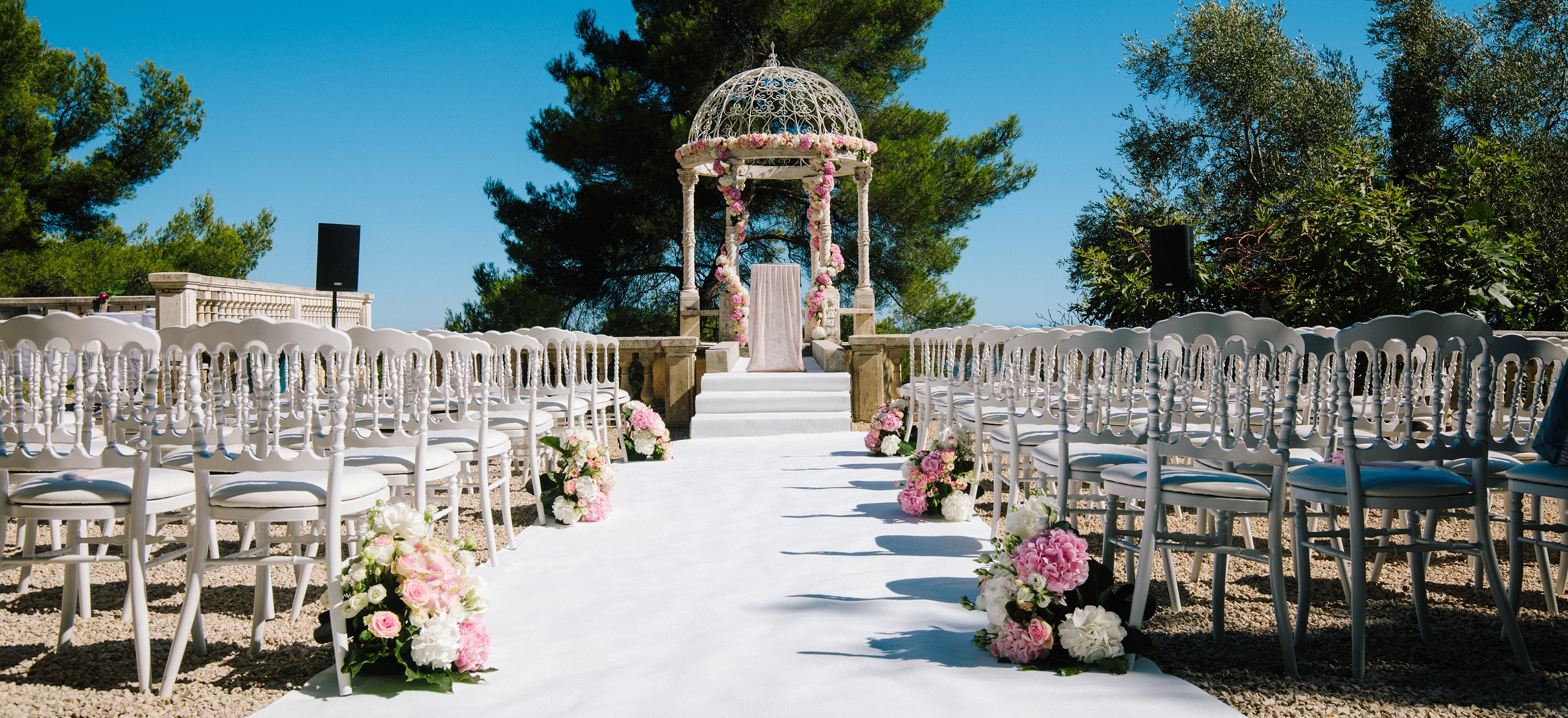 The aisle leading to the Temple of Love, set with chairs and flowers, Chateau Saint Georges