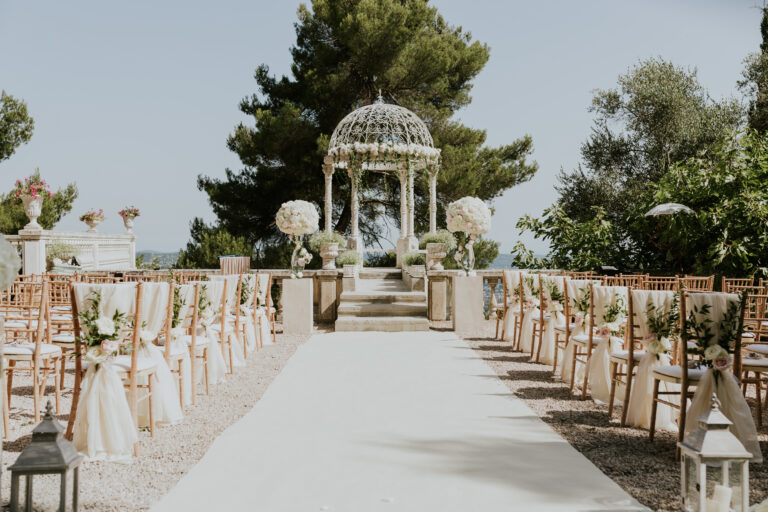 Chairs and a white aisle set before the Temple of Love, Chateau Saint Georges