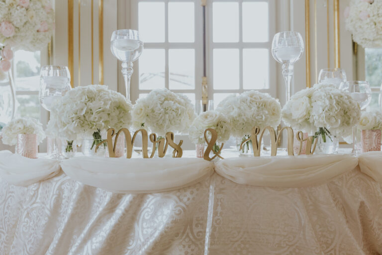 A head table dressed in white flowers, Chateau Saint Georges