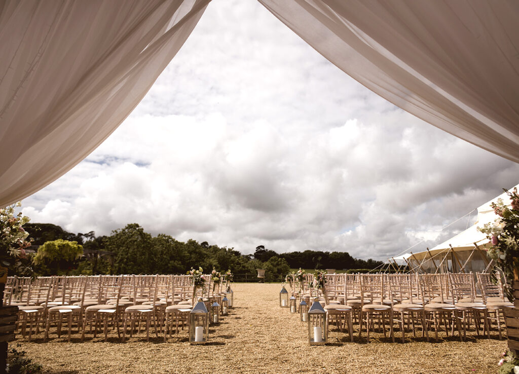 Long reception tables in a draped marquee, Chedington Grange