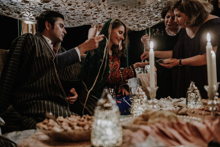 Persian ceremony table with candles and lanterns, guests gathered around the couple, Cherry On Top