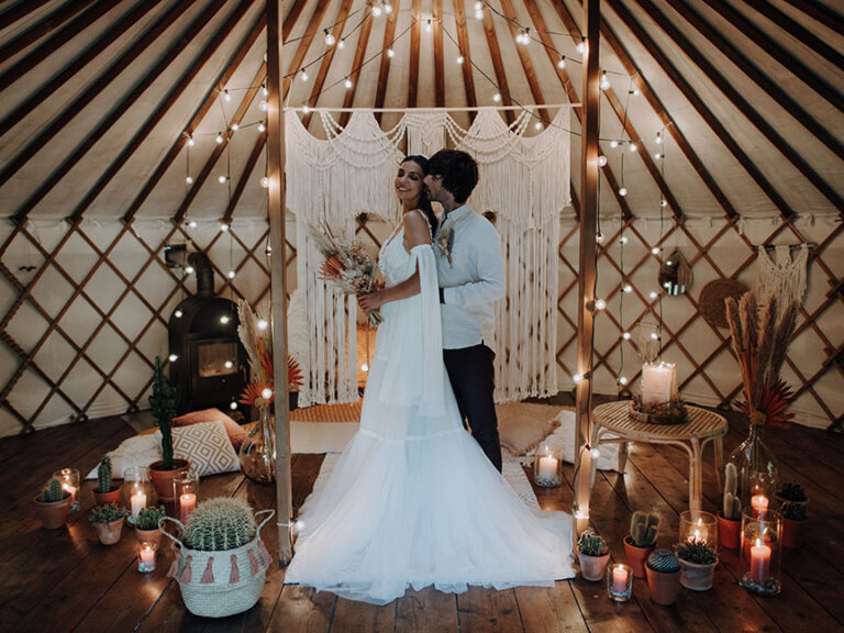 Couple dancing in a yurt hung with macramé, lights and candles, Cherry On Top