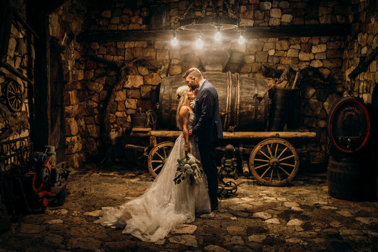 Couple embracing in a rustic stone cellar beside an old cart, Cherry On Top