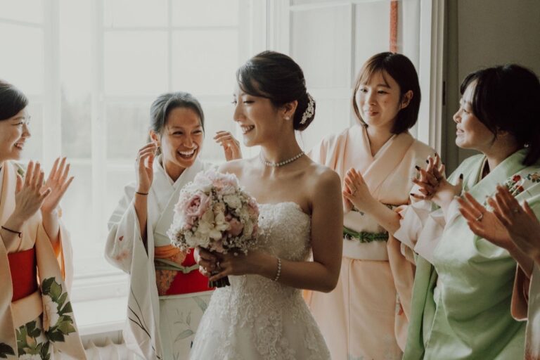 Bride with guests in kimonos laughing and applauding, Cherry On Top