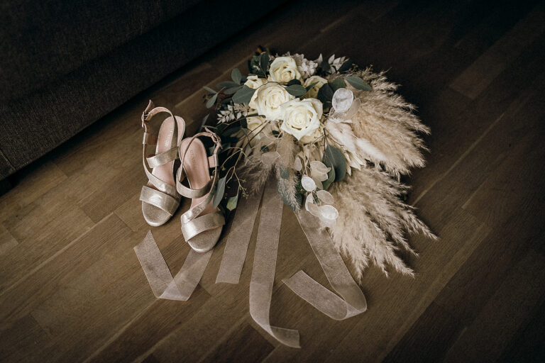 Bridal shoes and a pampas-and-rose bouquet on a dark wooden floor, Cherry On Top