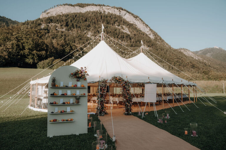 White marquee on a mountain meadow with a sweet-table display at the entrance, Cherry On Top