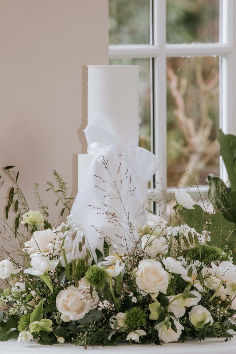 A three-tier wedding cake in the Glass House, Chewton Glen Hotel & Spa