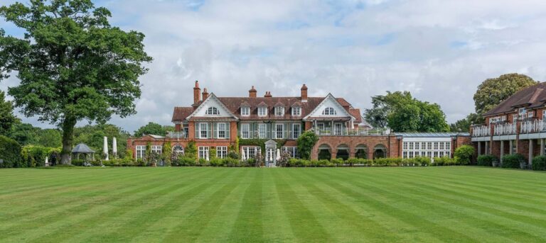 The house and its facade across the croquet lawn in summer, Chewton Glen Hotel & Spa