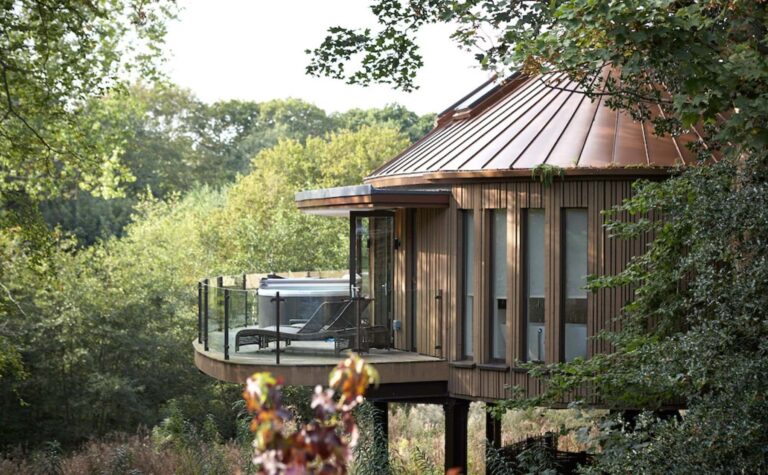 A Treehouse exterior amid autumn woodland, Chewton Glen Hotel & Spa