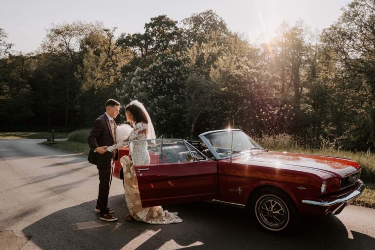 A vintage wedding car with the couple, Chewton Glen Hotel & Spa