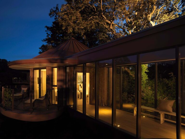 A Treehouse Hideaway lit at dusk, Chewton Glen Hotel & Spa
