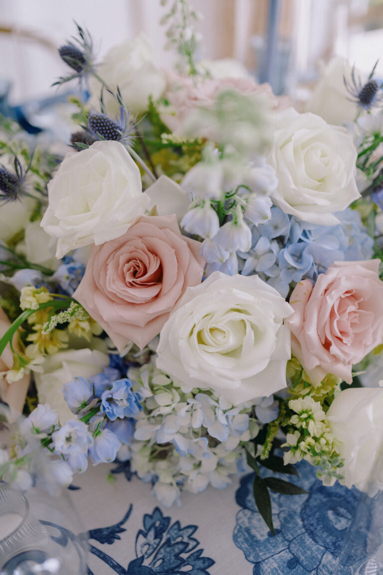 Close view of pink and white roses with blue hydrangea in a blue-and-white vase, Chic Bahamas Weddings