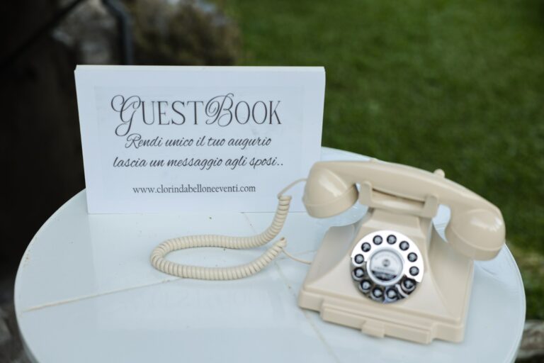 An audio guestbook: a cream vintage telephone with a sign asking guests to leave the couple a message, Clorinda Bellone Elite Weddings