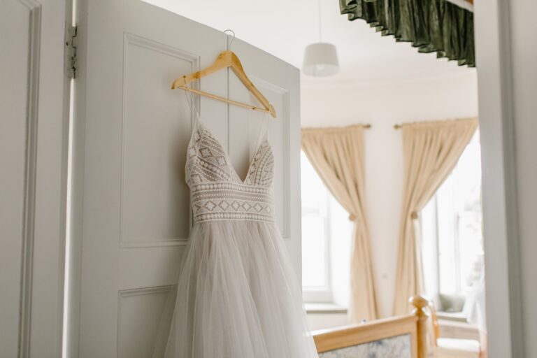 A lace wedding dress hanging on a bedroom door, Cluny Castle