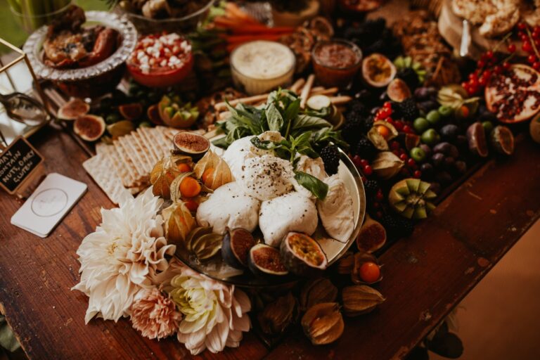 A grazing table of burrata, figs, fruit and bread set with dahlias, Cluny Castle