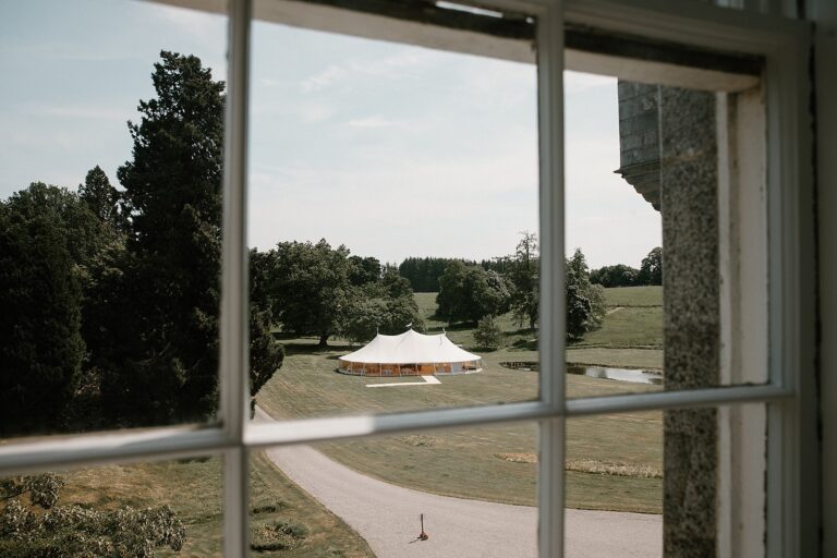 A sailcloth marquee on the lawn, seen from a castle window above the drive, Cluny Castle