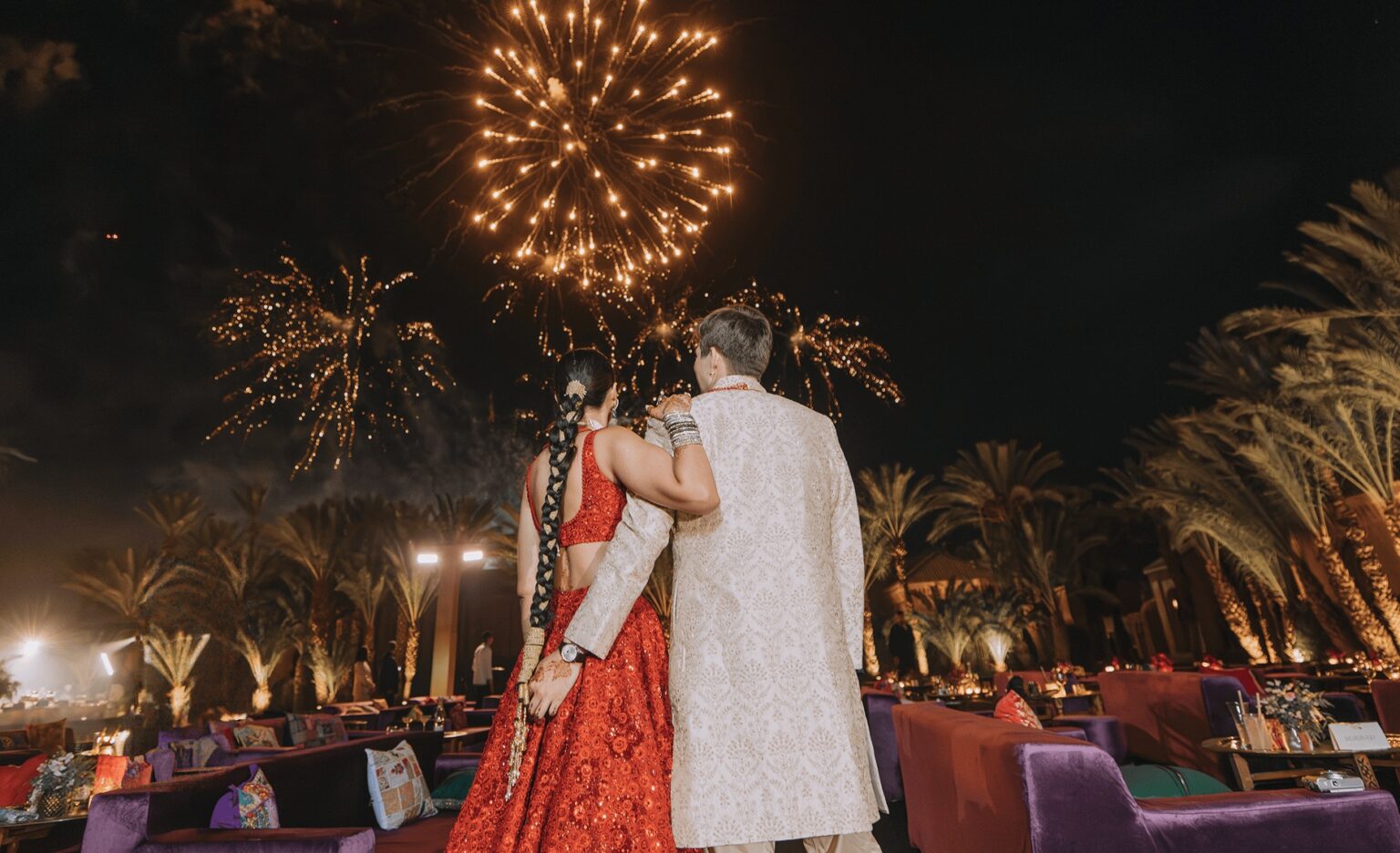 A couple watching fireworks over the reception