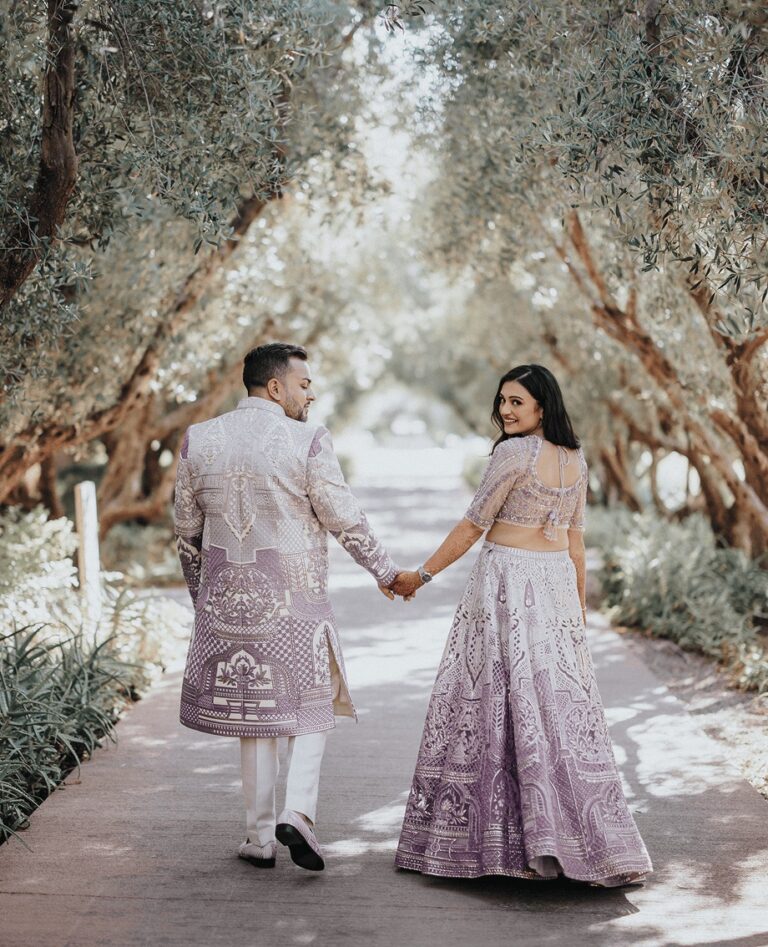 Couple walking hand in hand through an olive grove, Cocoon Events