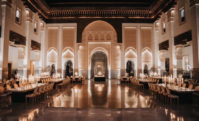 Long candlelit reception tables in a palace hall, Cocoon Events