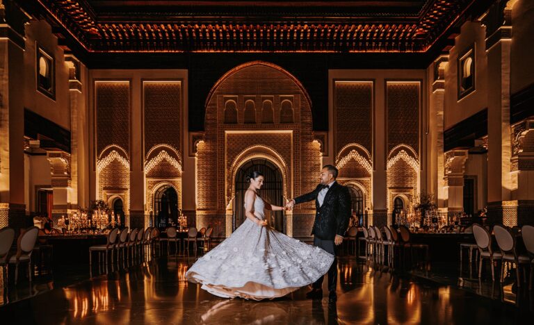 Bride and groom dancing in an ornate illuminated hall, Cocoon Events