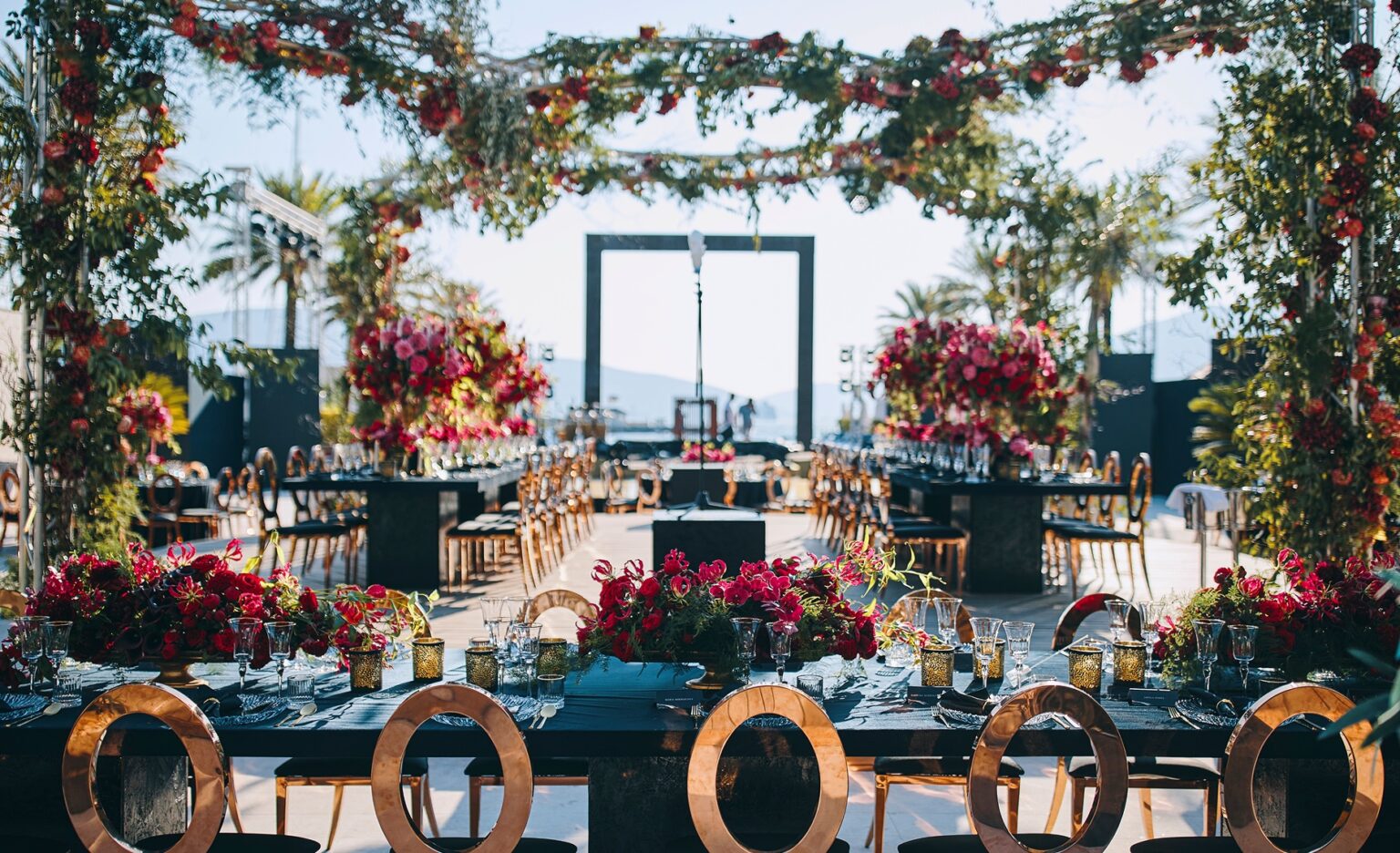 Dining tables under a hanging floral canopy