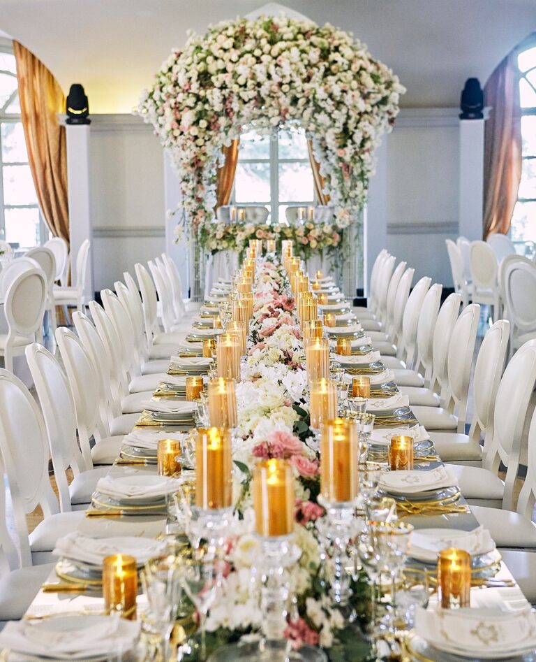 Long banquet table with gold candles and white flowers, Cocoon Events