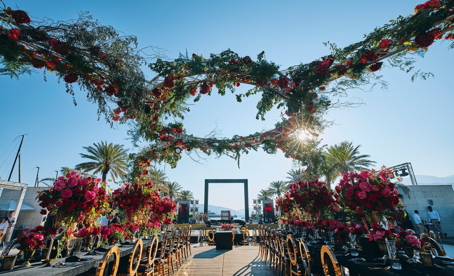 Floral gateway above a reception terrace by the water, Cocoon Events