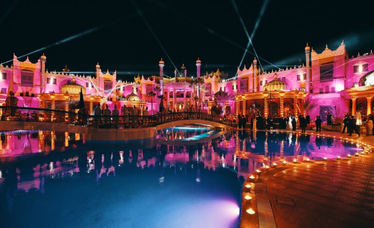 Palace and pool lit in pink and gold for an evening celebration, Cocoon Events