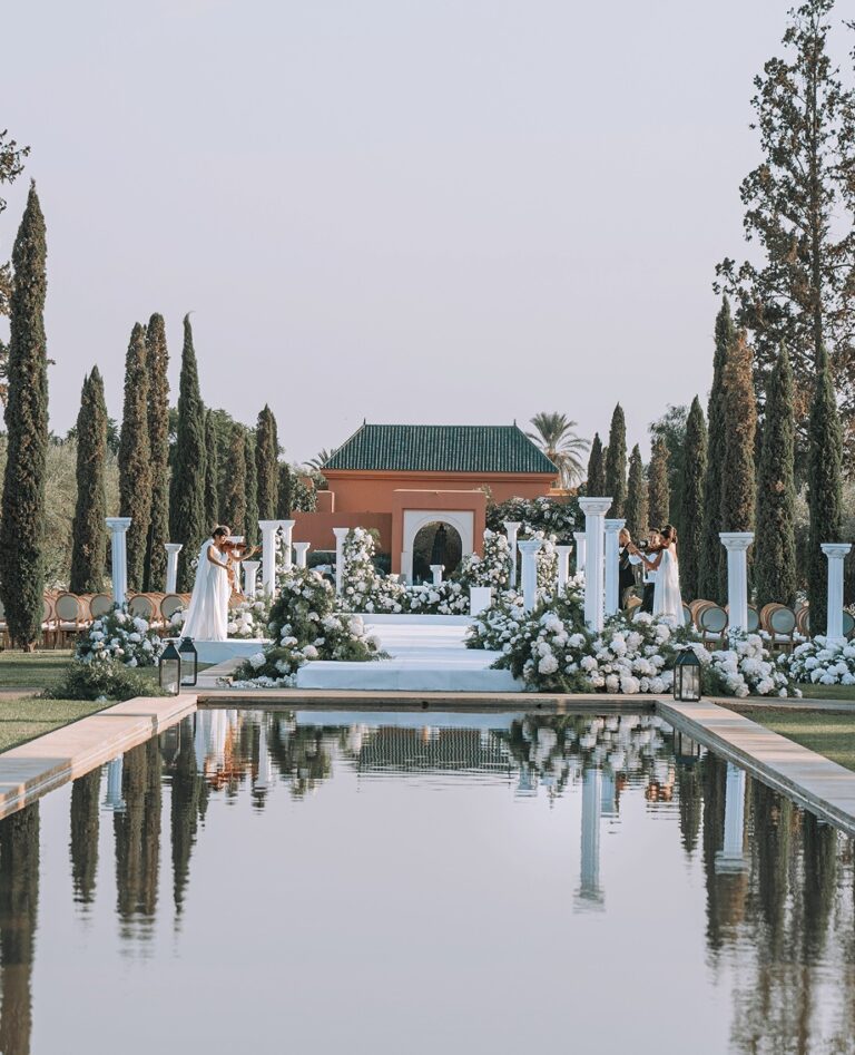 Reflecting pool with a floral installation and pavilion beyond, Cocoon Events