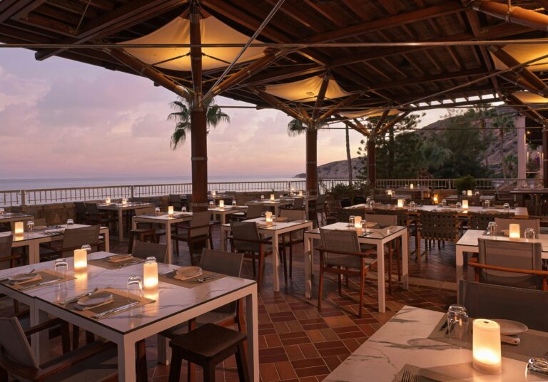 Cape Aspro Pergola laid for dinner at dusk, Columbia Beach Resort