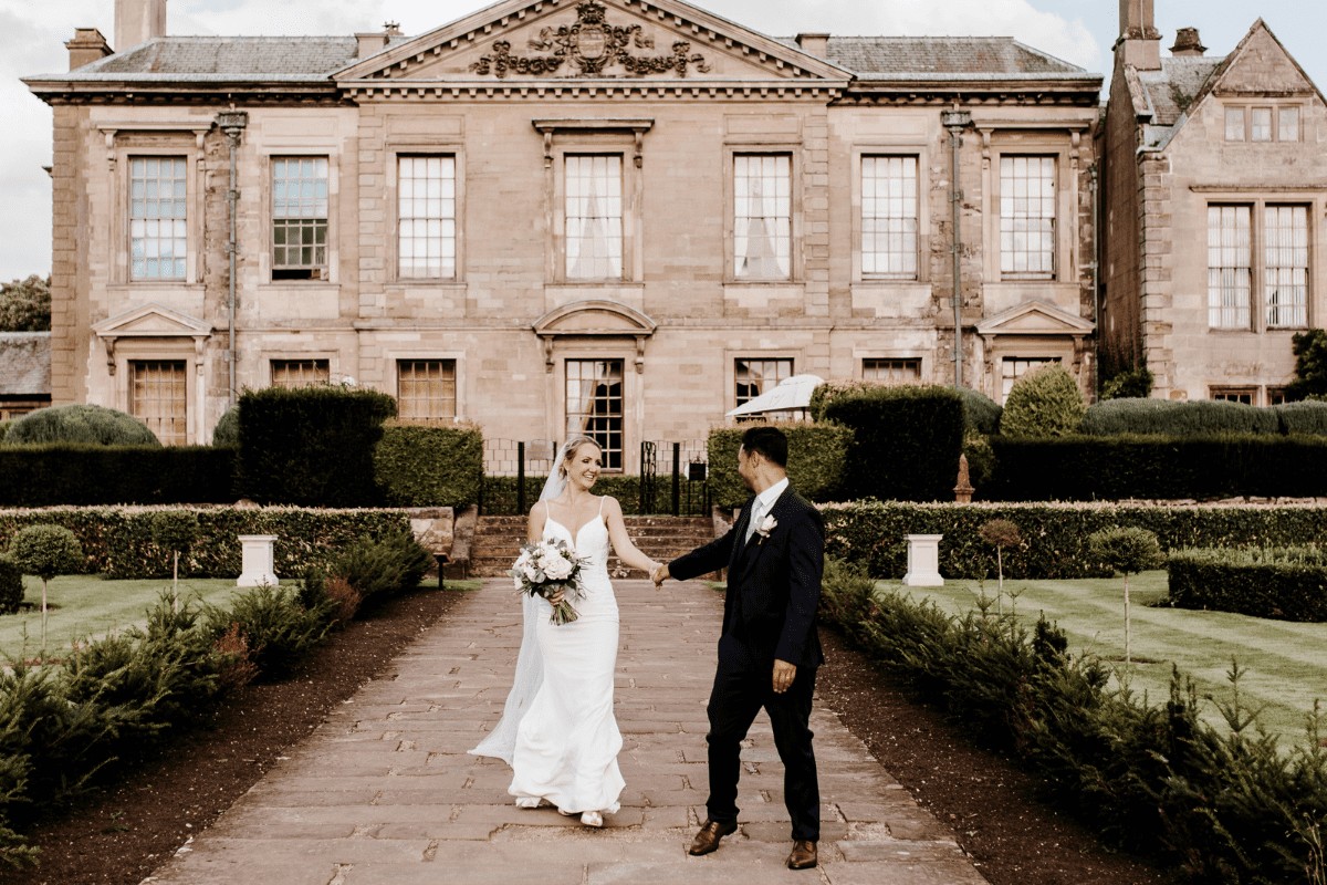 A couple in front of the hotel facade, Coombe Abbey