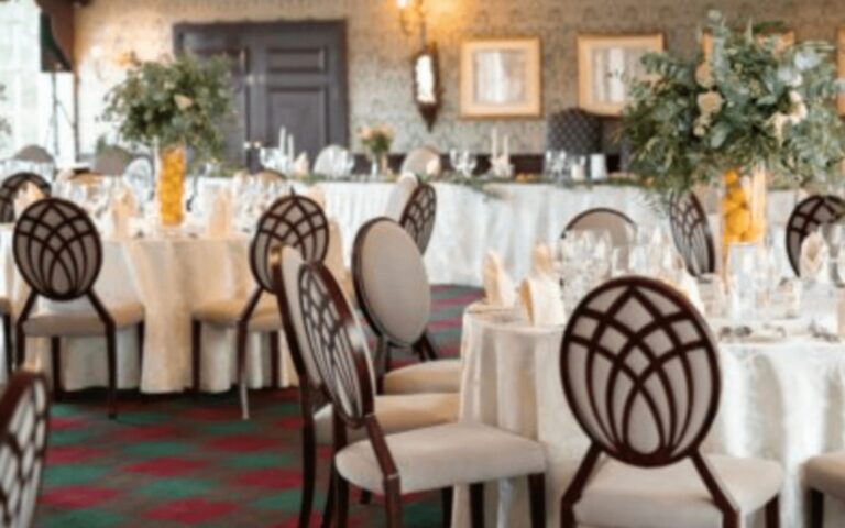 Tables laid with flowers in a reception room, Coombe Abbey