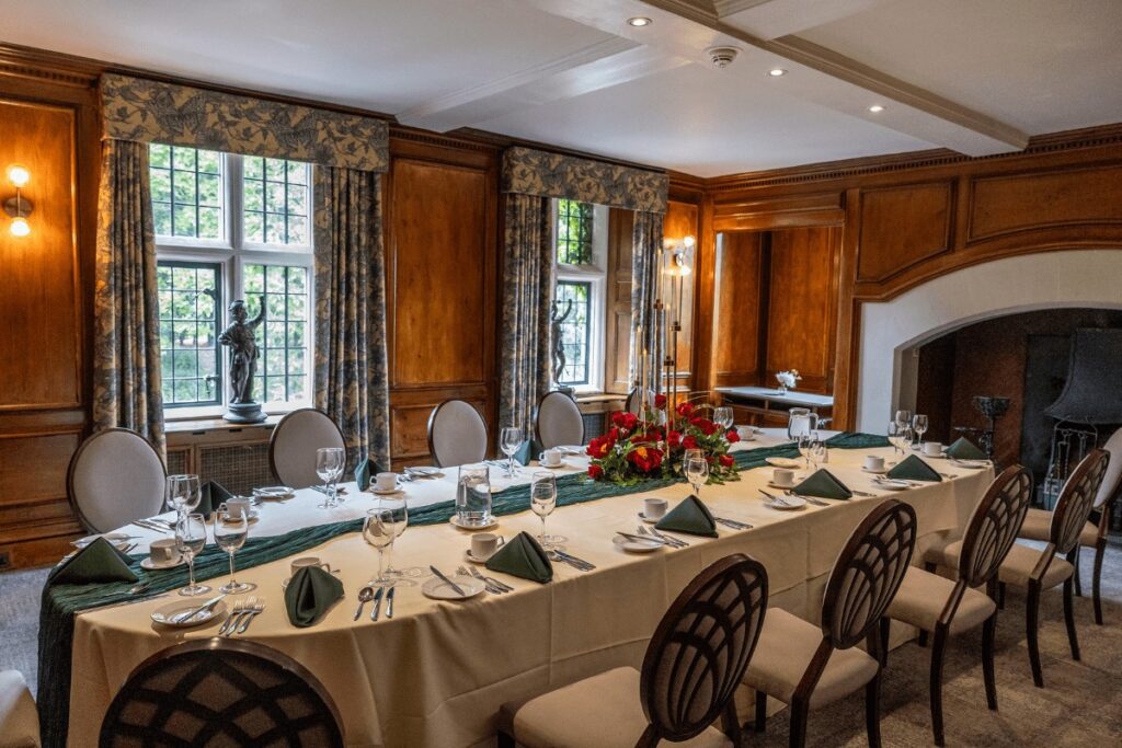 A panelled room with a long table laid, Coombe Abbey