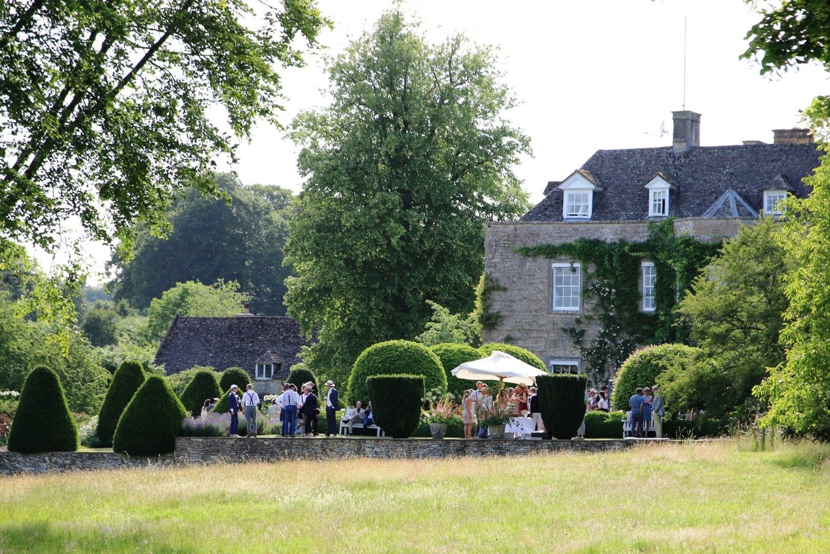 Guests gathered in the gardens beside the house, Cornwell Manor