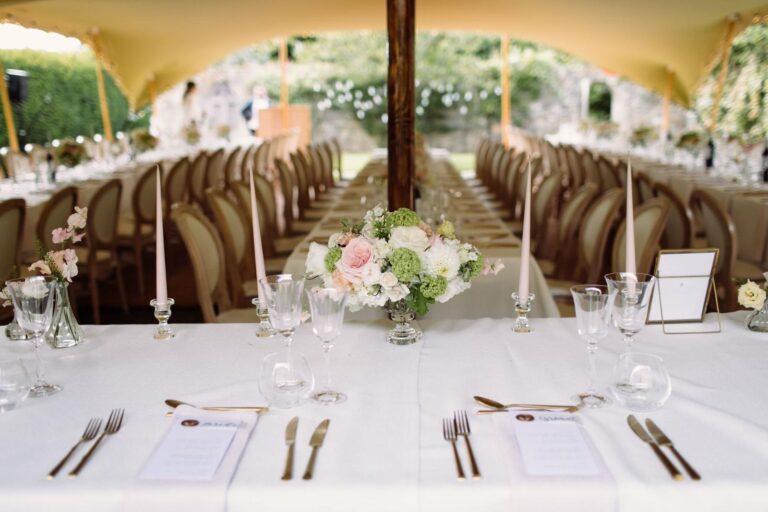 A long wedding table laid in a marquee, Cornwell Manor