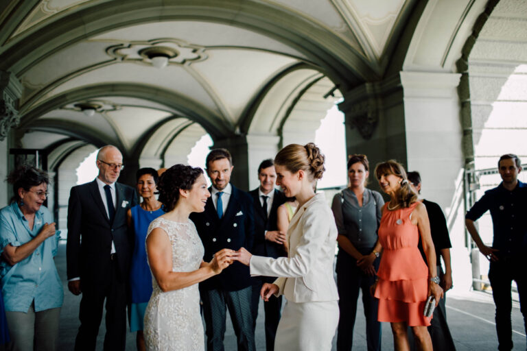 Exchanging rings with family under the stone arcades of Bern, Switzerland, Cottonwood Studios